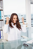 Cheerful businesswoman cheering in office