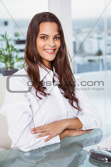 Beautiful businesswoman sitting at office desk
