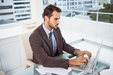 Businessman using laptop in office