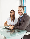 Smiling business people at office desk