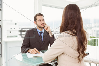 Businessman interviewing woman in office