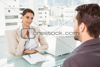 Businesswoman interviewing man in office