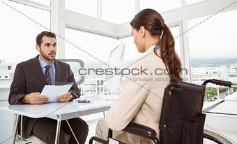 Businessman interviewing woman in office