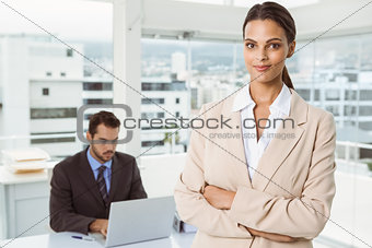 Beautiful businesswoman with arms crossed at office