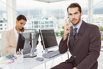 Business people using computers in office