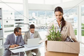 Businesswoman carrying her belongings in box