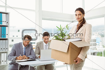 Businesswoman carrying her belongings in box