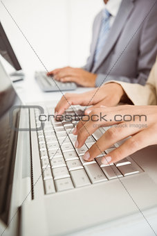 Hands using computers in office