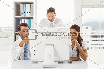 Business people using computer in office