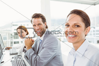 Business people using computers in office