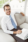 Businessman using laptop in living room