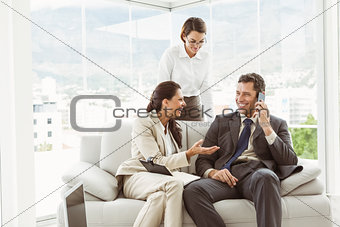 Business people in discussion in living room