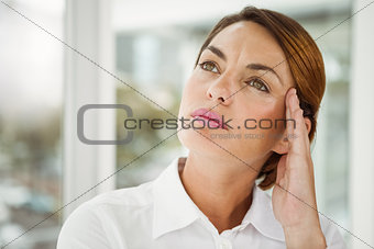 Thoughtful businesswoman looking away at office