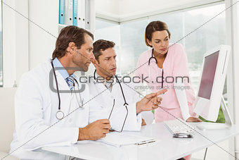 Doctors using computer at medical office