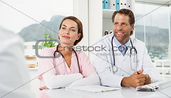 Doctors in discussion with patient in medical office