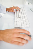 Close-up of hands using computer keyboard