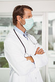 Male doctor wearing surgical mask in hospital