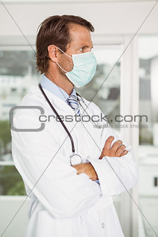 Male doctor wearing surgical mask in hospital