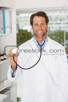 Confident male doctor with stethoscope in hospital