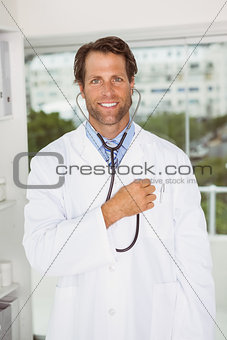Confident male doctor with stethoscope in hospital
