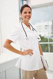 Confident female doctor with stethoscope at medical office