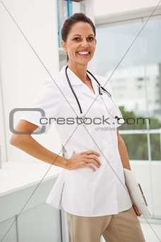 Confident female doctor with stethoscope at medical office
