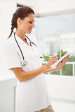 Female doctor using digital tablet in medical office