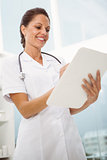 Female doctor holding clipboard in medical office