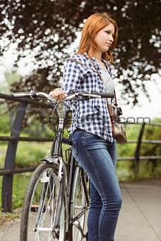 Redhead standing next to her bike