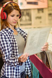 Girl looking for vinyl while listening to music