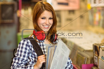 Smiling girl holding some vinyls