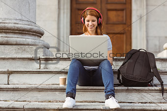 Happy enjoying woman listening with headphones to music