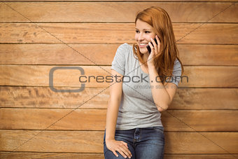 Pretty happy redhead phoning with mobile phone