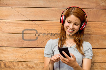 Girl listening music with headphones while sending message