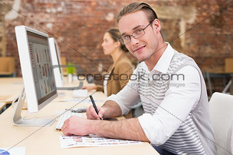 Male photo editor using digitizer in office