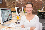 Smiling female photo editor in office