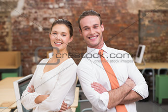 Two smiling business colleagues in office
