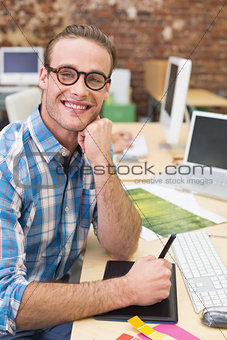 Smiling male photo editor in office