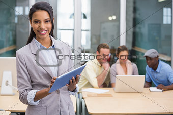 Smiling businesswoman with colleagues in office