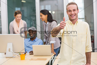 Smiling businessman with colleagues in office