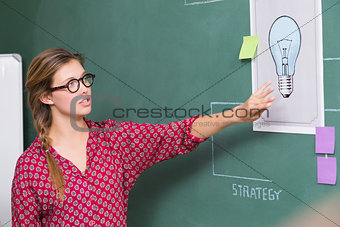 Creative businesswoman at work by blackboard