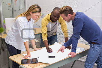 Interior designers looking at blueprint