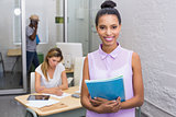 Casual woman with colleague behind in office