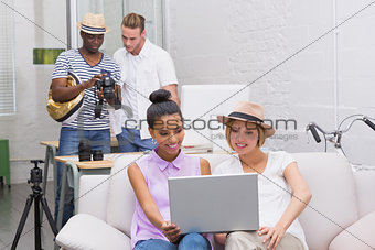 Casual business people using laptop
