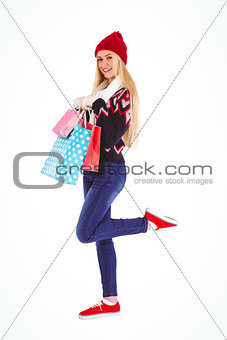 Festive blonde holding shopping bags