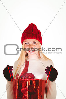 Festive blonde opening a gift bag