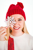 Festive blonde holding snowflake decoration