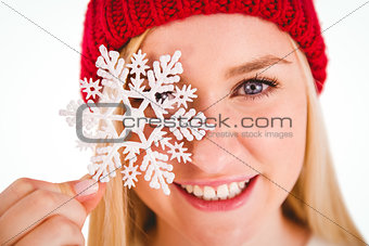 Festive blonde holding snowflake decoration