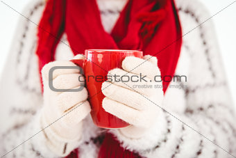 Woman in warm clothing holding mug