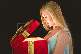 Festive blonde opening a gift